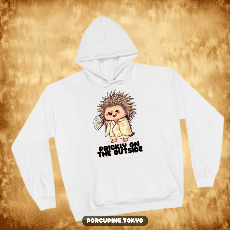 Funny porcupine character in a patterned kimono shaking a fan, showcasing playful energy on a warm hoodie.